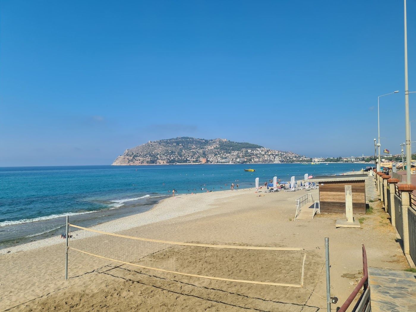 Palm lined Portakal Beach on the harbour side of the castle headland in central Alanya