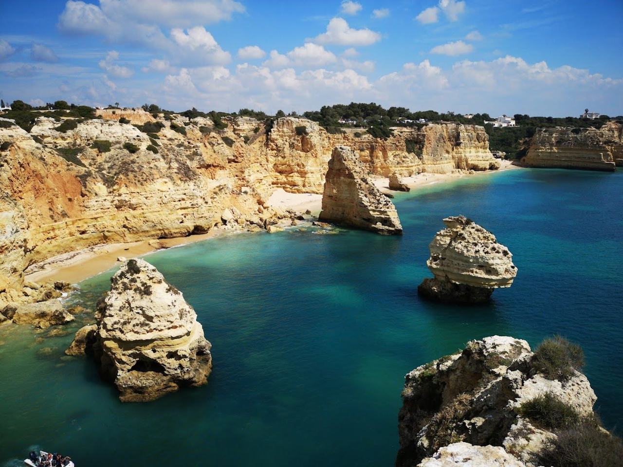 Golden sandstone cliffs and a sheltered cove in the Algarve