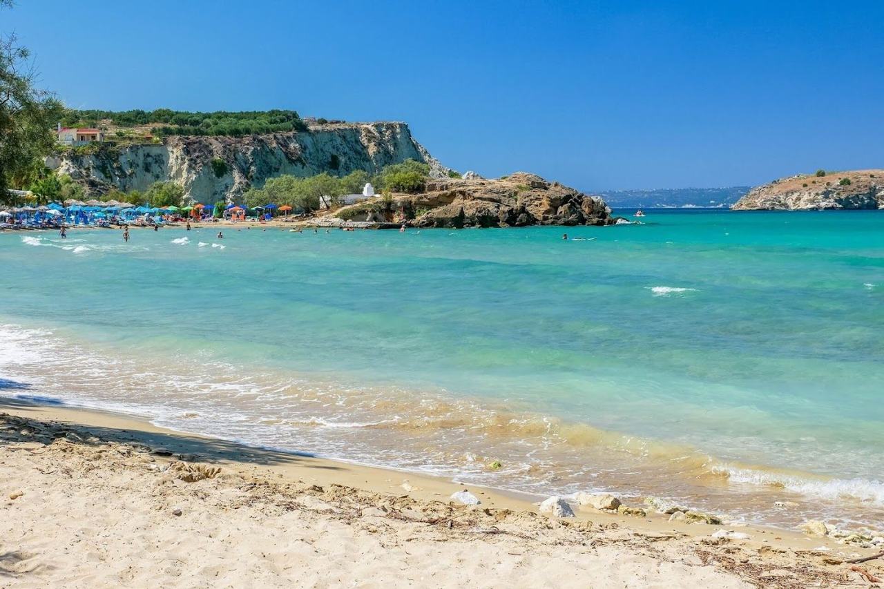 Shallow calm water and sunbeds at the sheltered bay of Almyrida on the north coast of Crete