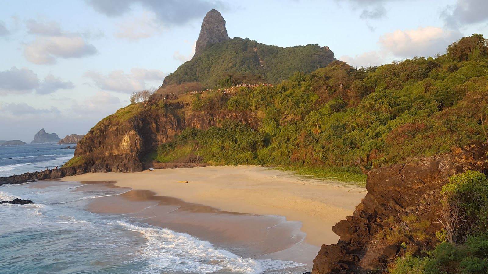 The small cliff framed cove of Praia do Americano on the calm side of Fernando de Noronha