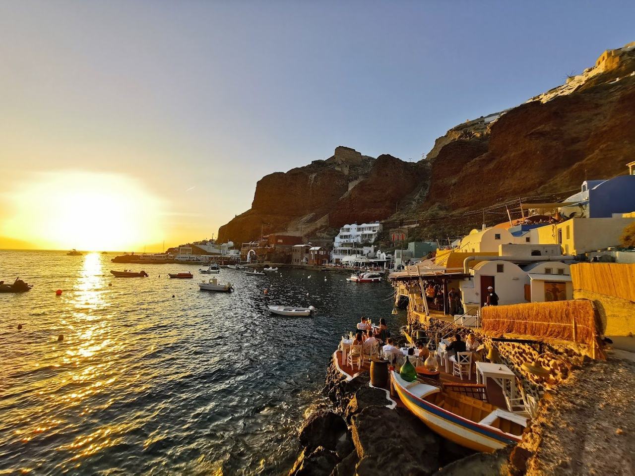 Waterside fish tavernas and red rock at Ammoudi Bay below Oia
