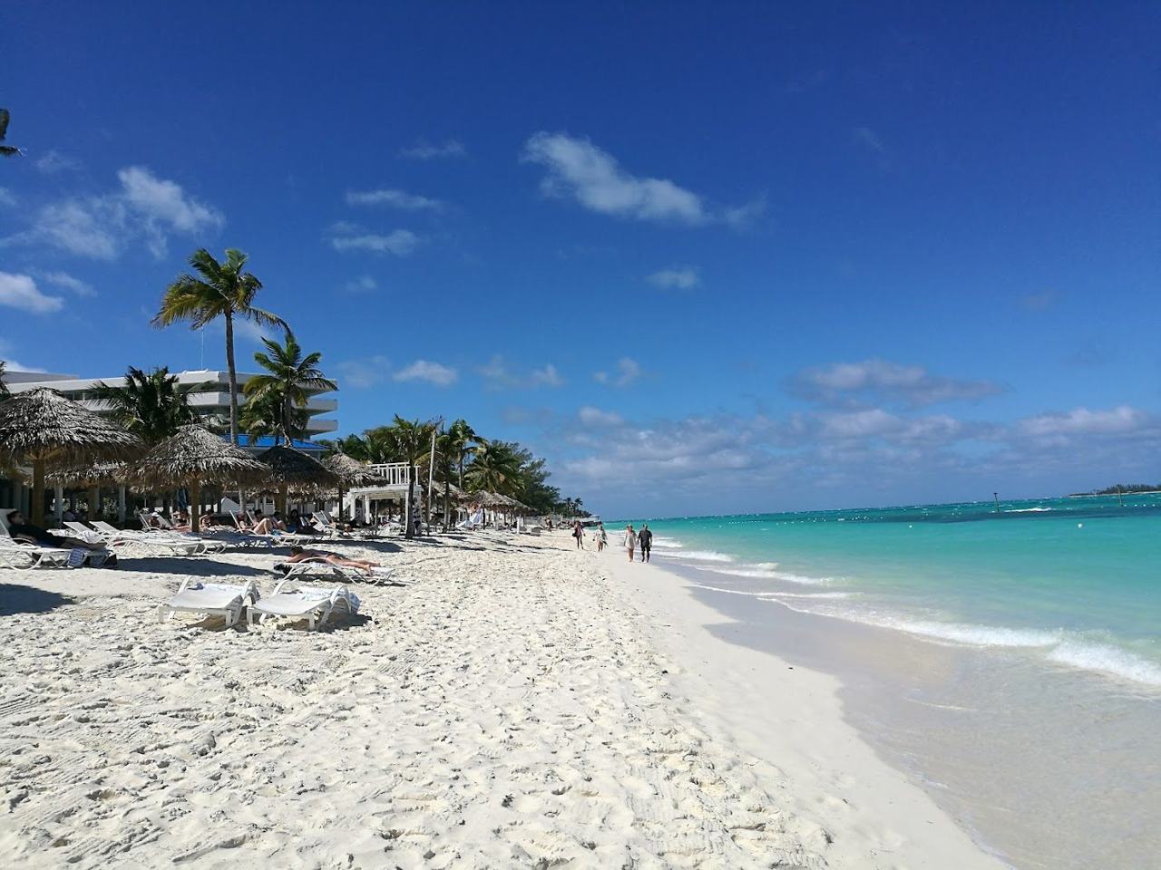 Loungers and calm clear water at a resort beach on Cable Beach near Nassau in the Bahamas