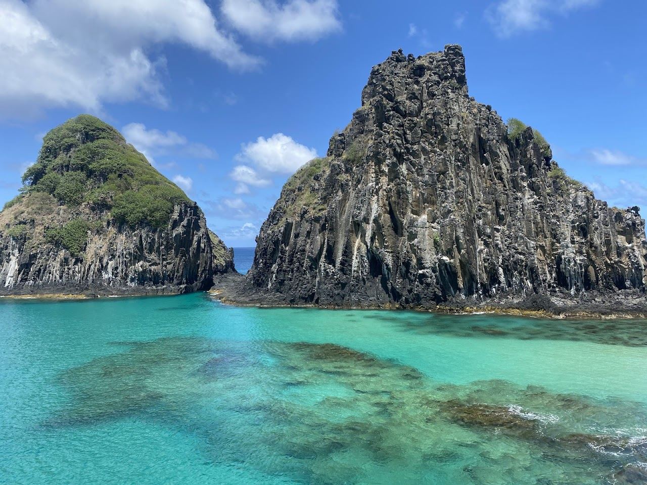 Natural rock pools and clear water at Baia dos Porcos below Morro Dois Irmaos