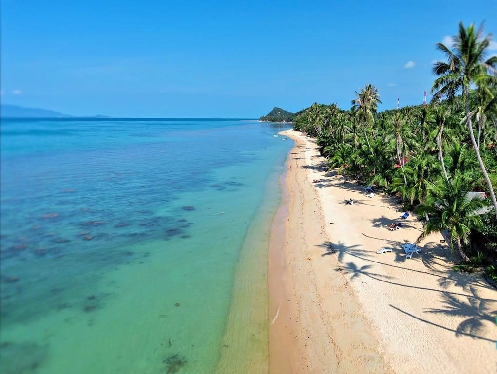 Quiet calm water at Bang Por Beach on the northwest coast of Koh Samui at golden light