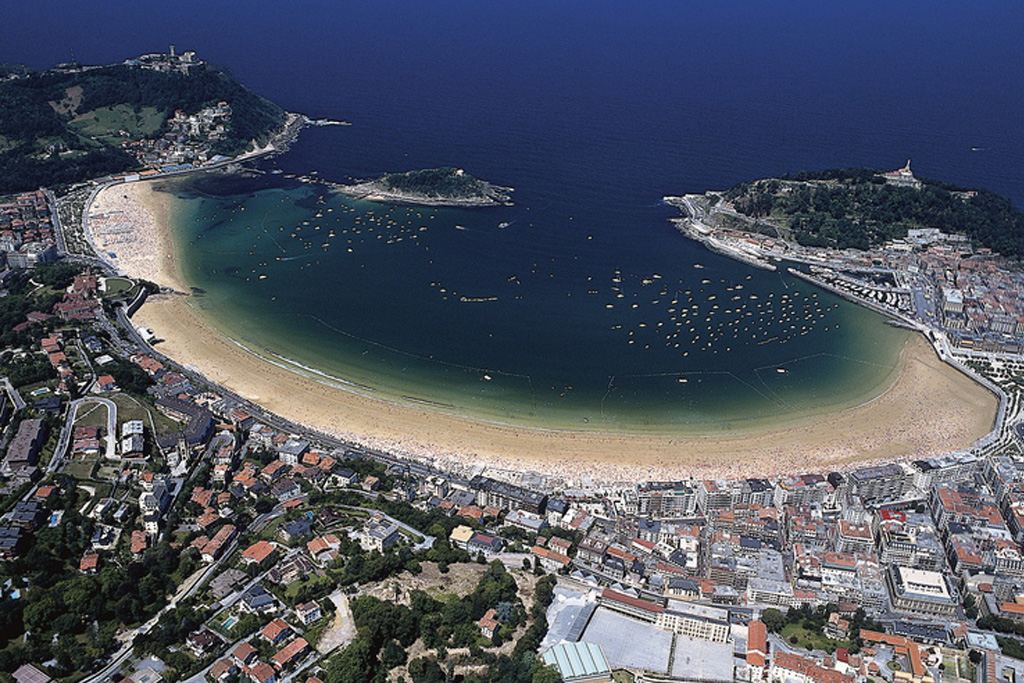 The wide golden crescent and calm water of La Concha bay in San Sebastian, a long standing Blue Flag beach in Spain