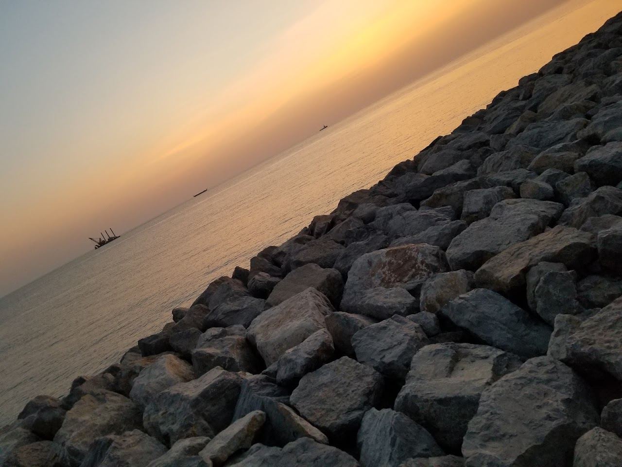 A wild sandbar and calm lagoon water with seabirds on the Ras Al Khaimah coast