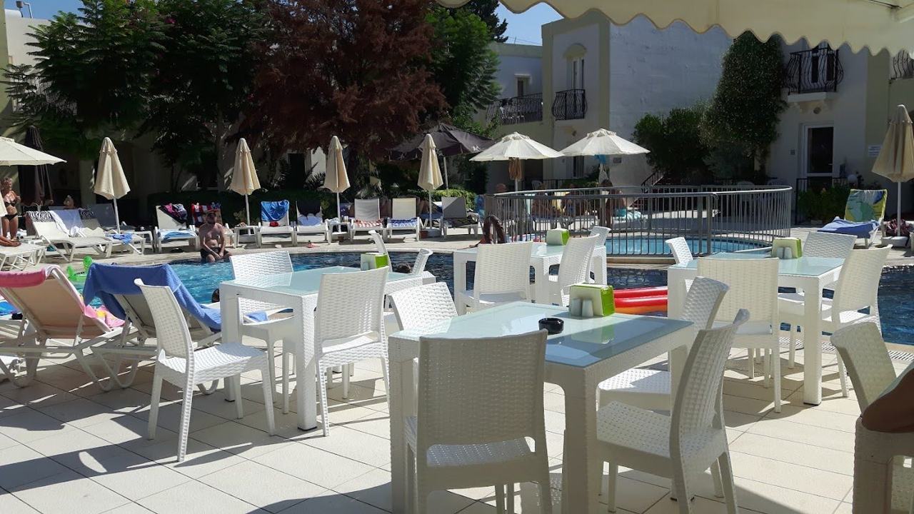 Calm shallow bay lined with loungers at Bitez near Bodrum
