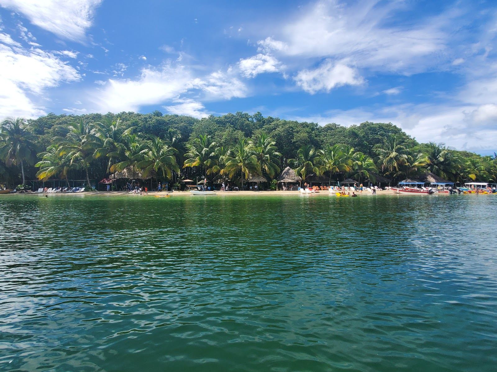 Calm clear shallow Caribbean water and soft sand at a sheltered beach in Bocas del Toro Panama