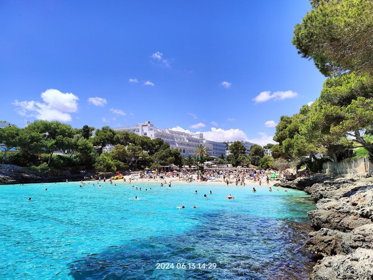 Cala d'Or turquoise cove between low cliffs in southeast Mallorca