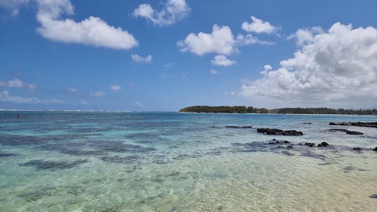 The glassy protected lagoon and clear shallow water of Blue Bay in Mauritius