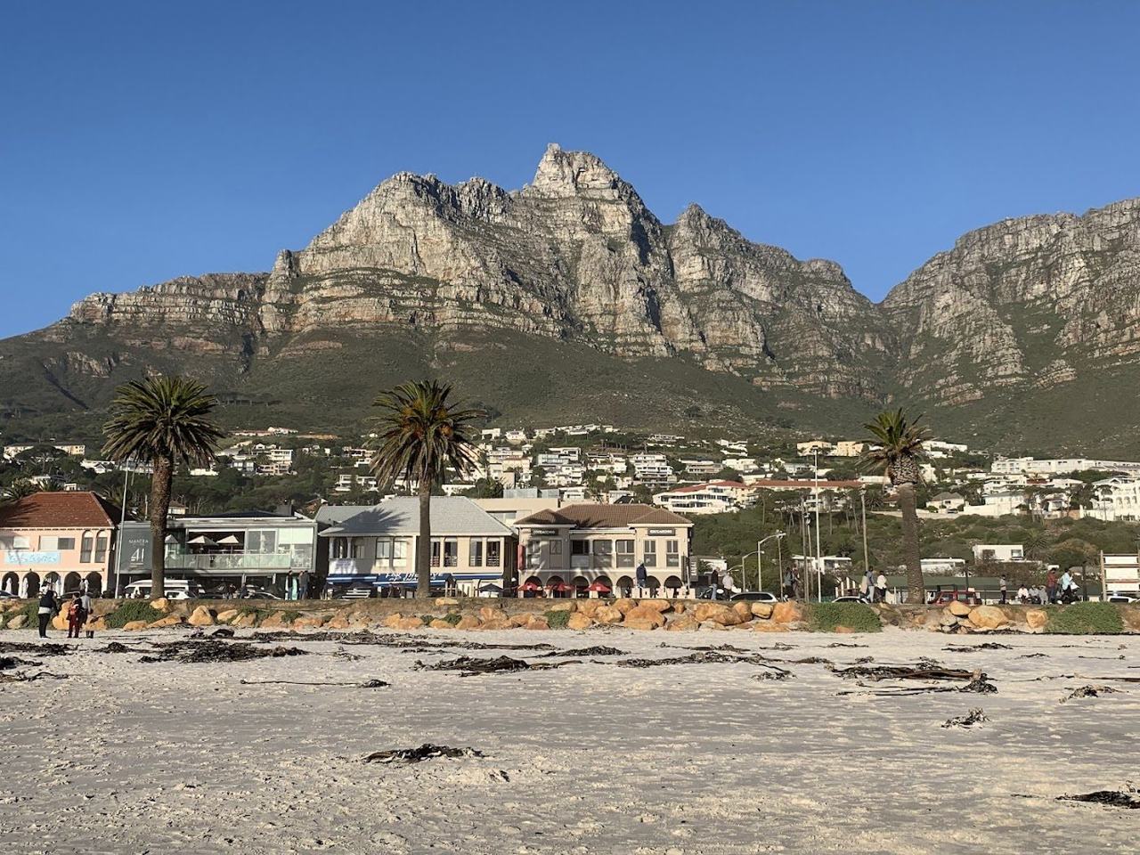 The wide white sand of Camps Bay beach below the Twelve Apostles just south of Clifton in Cape Town