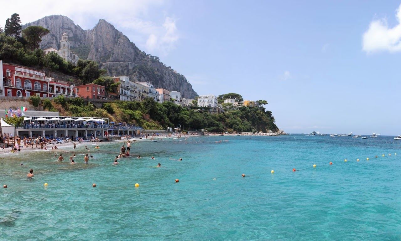 Calm sand and pebble beach at Marina Grande by the port in Capri
