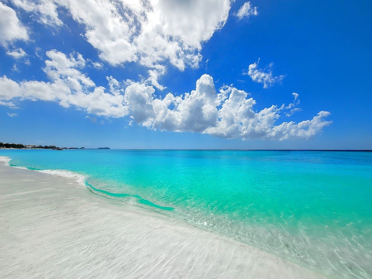 The wide quiet sand and calm sea at the north end of Seven Mile Beach near West Bay Grand Cayman