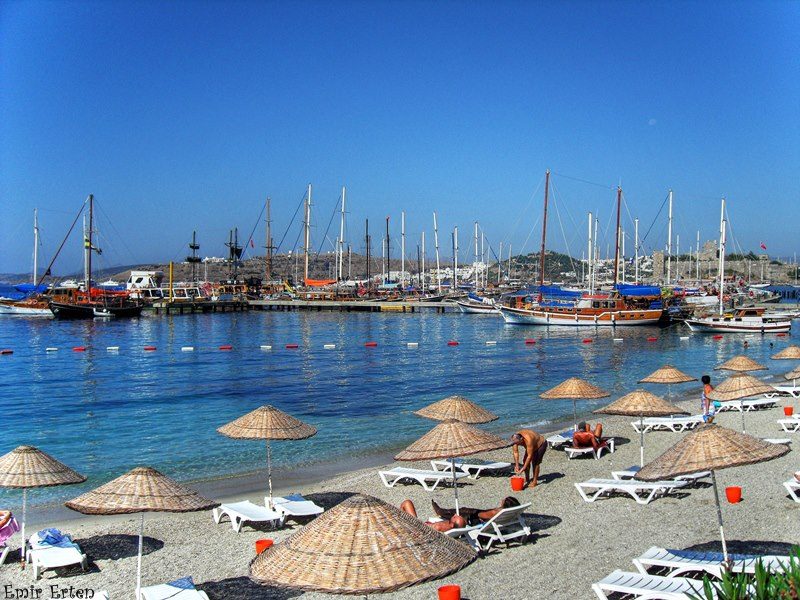 The harbour and town beach of Bodrum with the castle and turquoise water behind