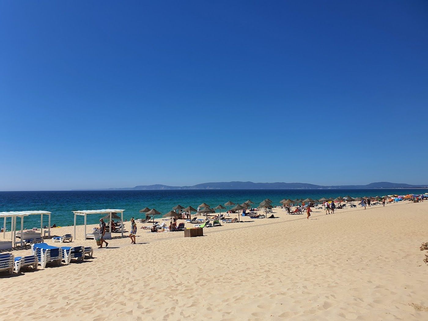 Wide pale Atlantic sand backed by dunes at Praia da Comporta in Portugal