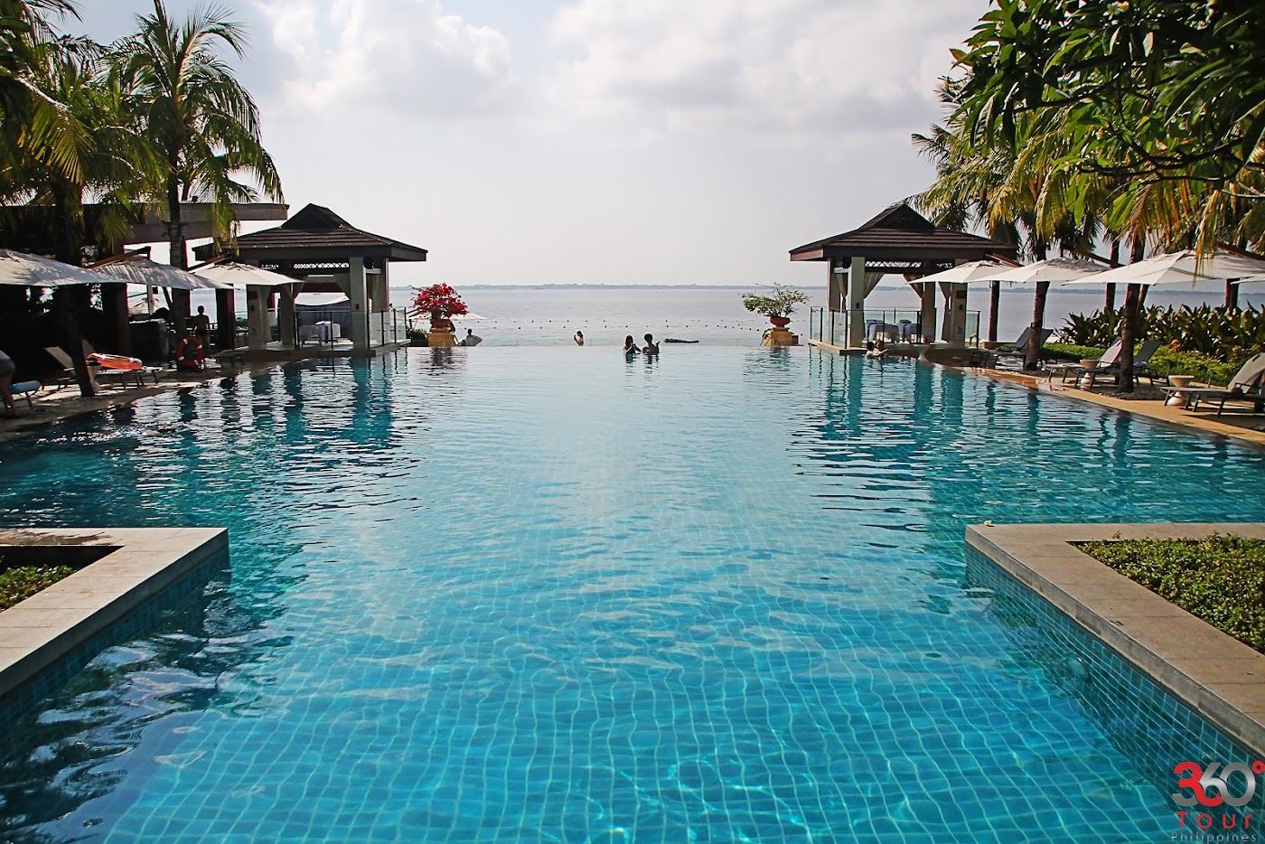 White sand beach and calm water at the Crimson Resort front in Seascapes on the Punta Engano tip of Mactan Island in Cebu Philippines