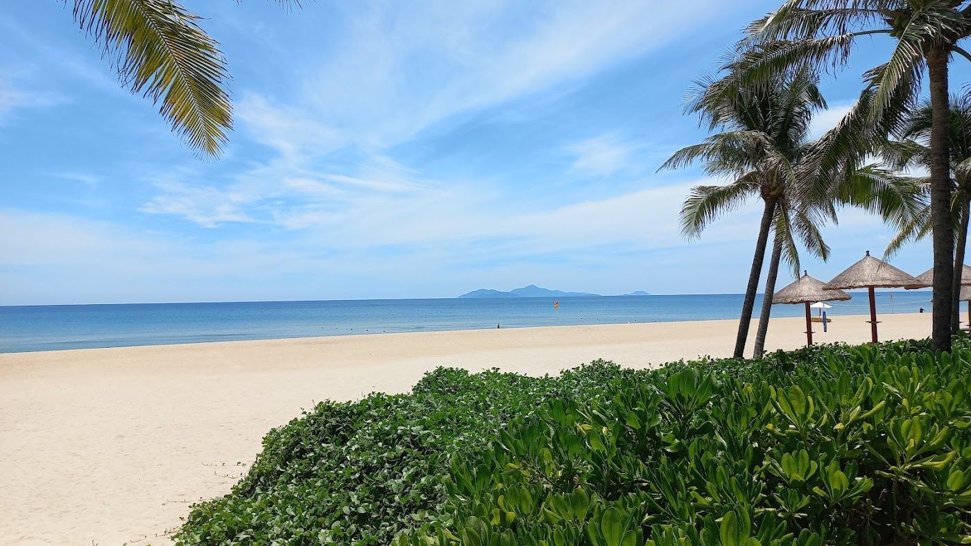 Calm shallow water and soft sand at Non Nuoc Beach below the Marble Mountains in Da Nang, Vietnam
