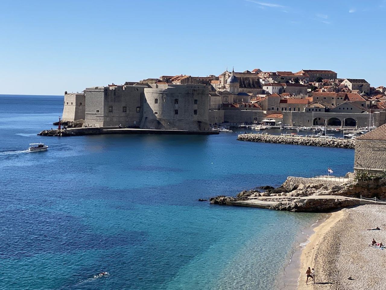 Pebble city beach below the Old Town walls at Banje in Dubrovnik