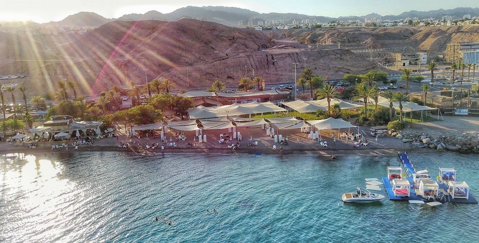 The beach restaurant and loungers on the sand at Dekel Beach in Eilat