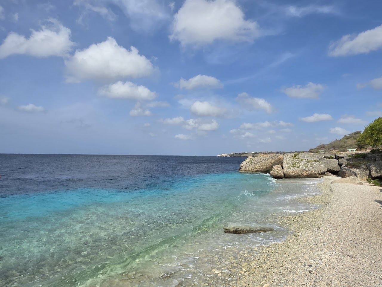 The calm clear water and rocky sheltered cove of Directors Bay on the Caracas Bay peninsula in Curacao