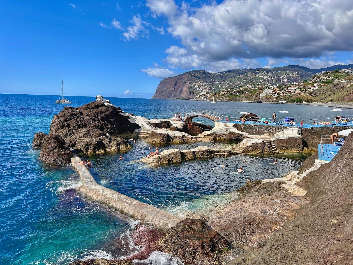 Natural seawater pools set into black volcanic rock below the Lido promenade at Doca do Cavacas in Funchal, Madeira