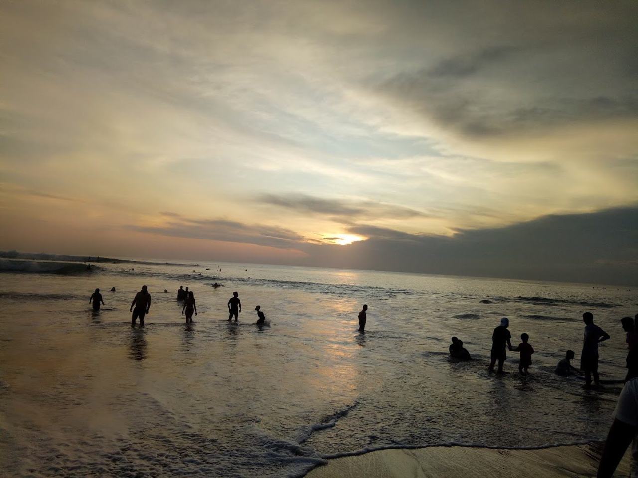 White sand and surf below limestone cliffs at Dreamland Beach in Bali