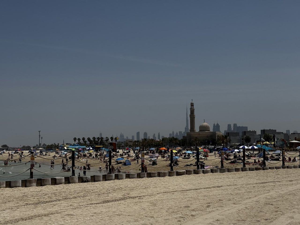 The calm shallow Gulf water and clean sand at Jumeirah Open Beach in Dubai