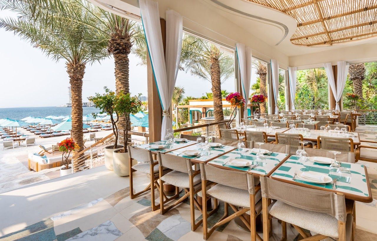 Beach club loungers and clear Gulf water on the Jumeirah coast of Dubai