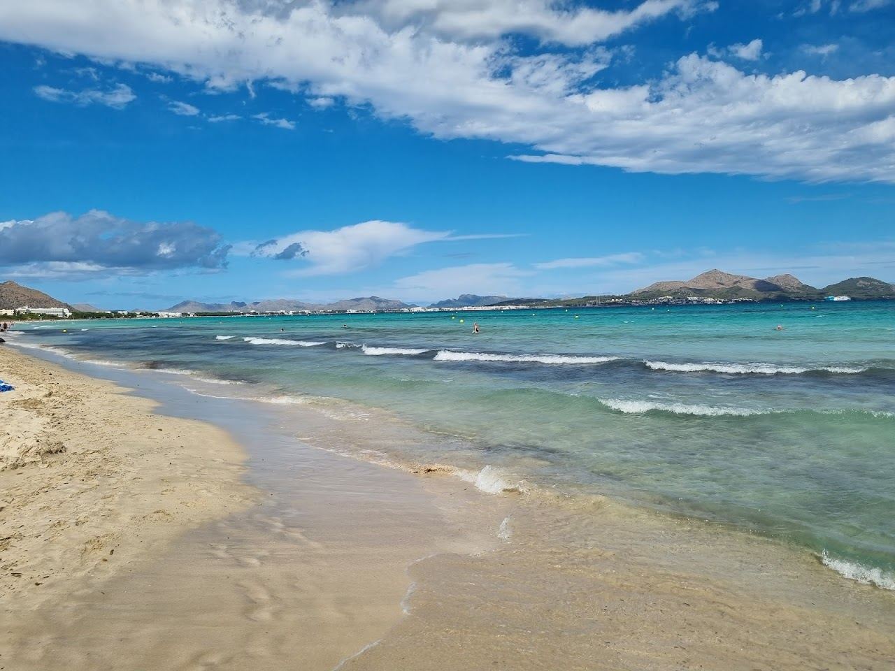 The wide shallow shelf and fine pale sand of Playa de Muro near Alcudia