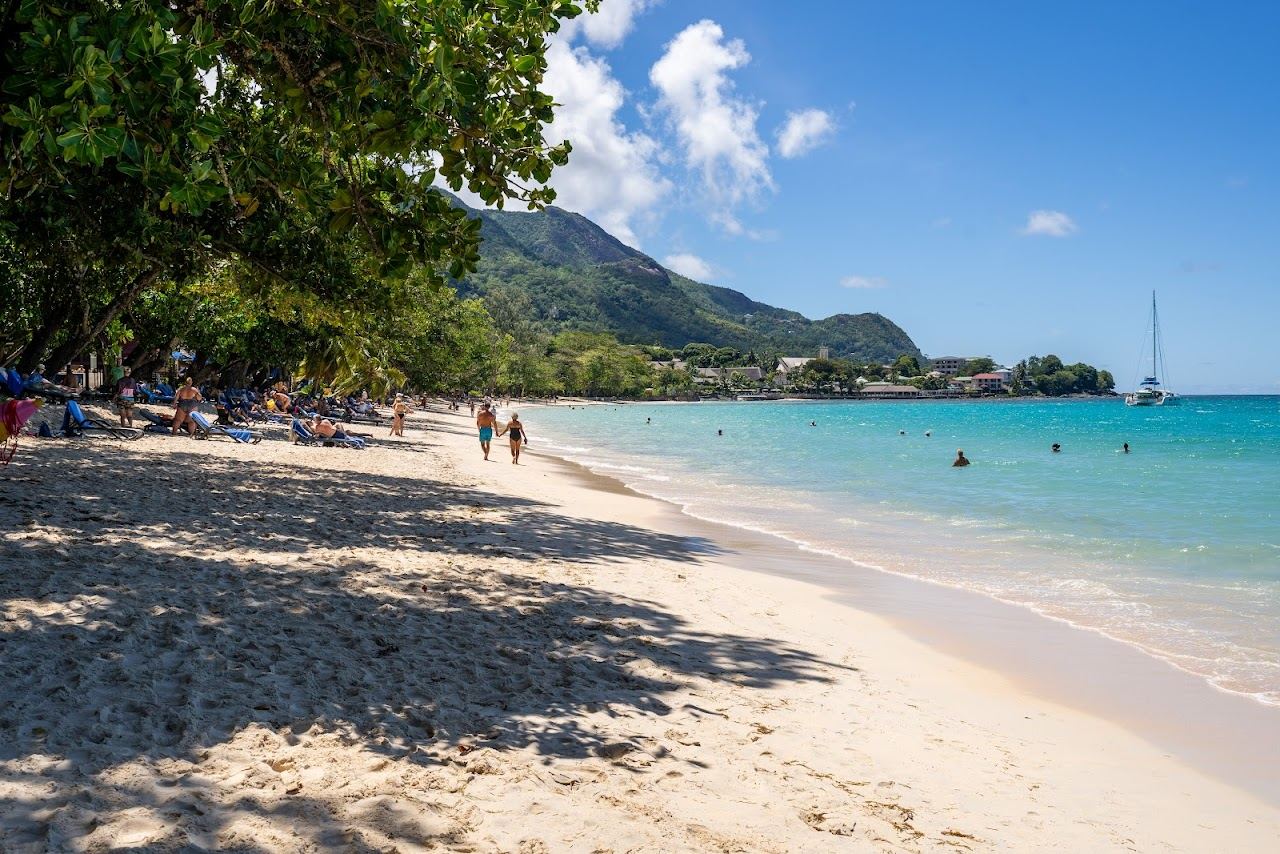 The long gently shelving sand and calm water of Beau Vallon on Mahe