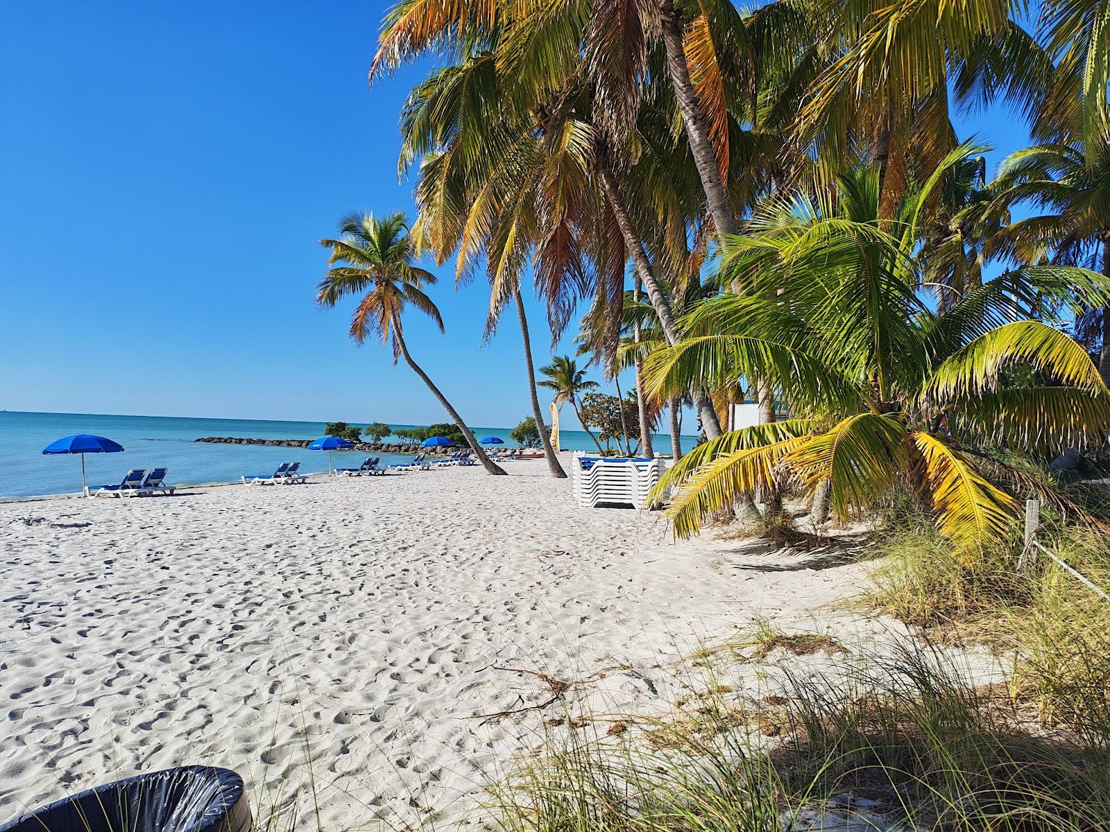 The long open sand and shallow calm water of Smathers Beach along South Roosevelt Boulevard in Key West