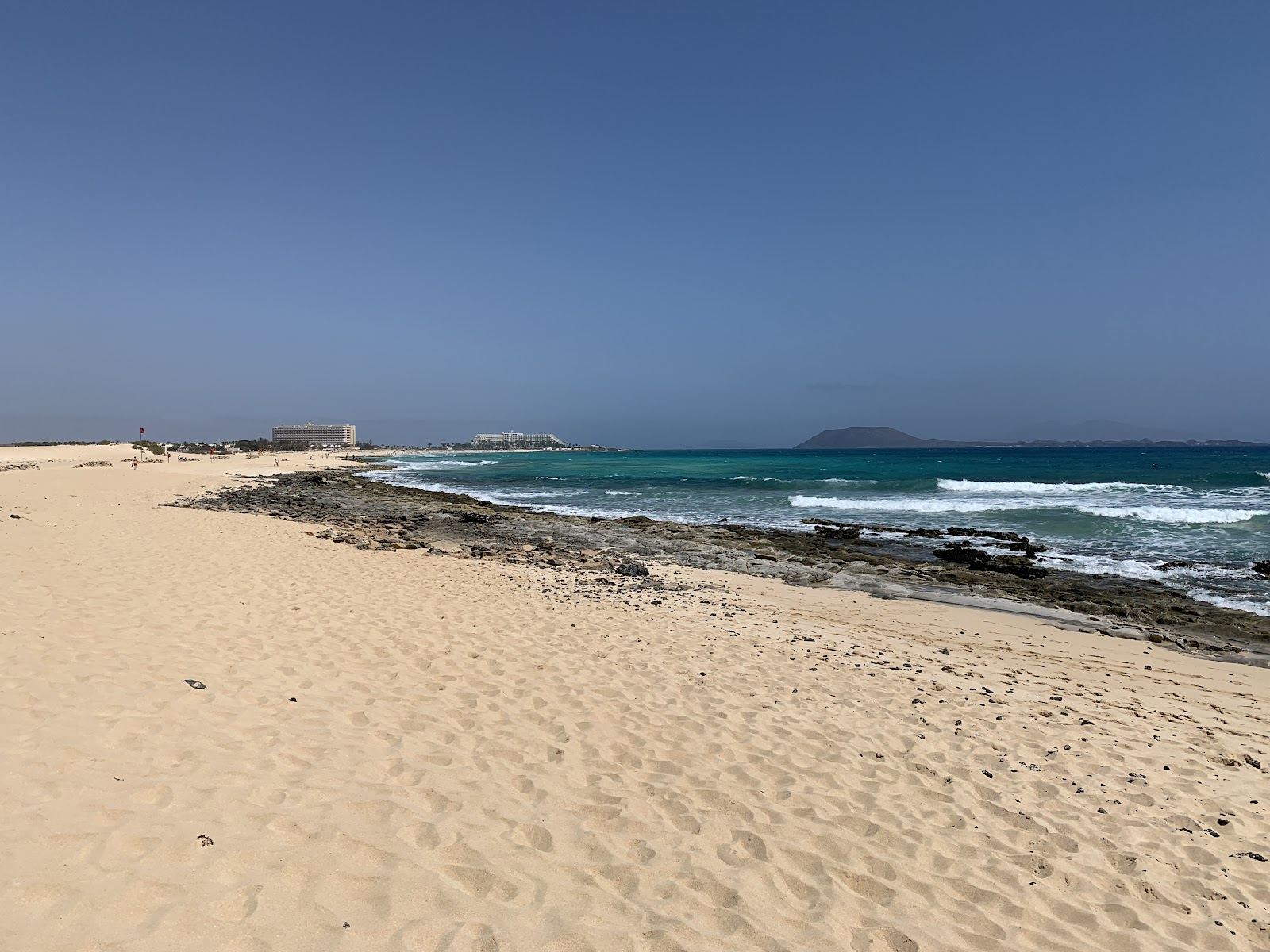 Golden sand and turquoise sea on the dune coast near Corralejo in Fuerteventura