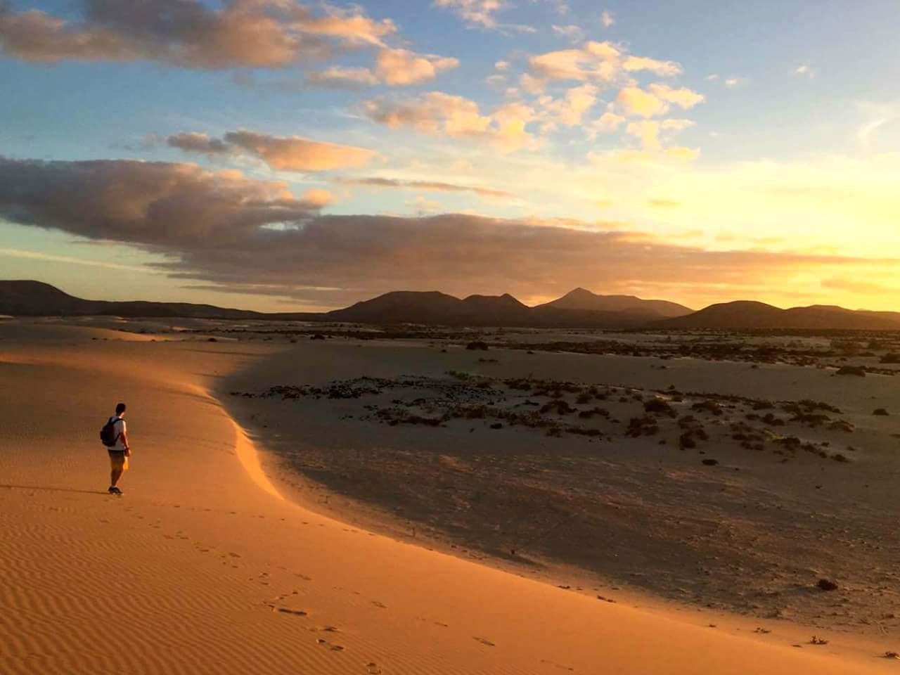 Golden sand and turquoise sea on the natural dune coast near Corralejo in Fuerteventura