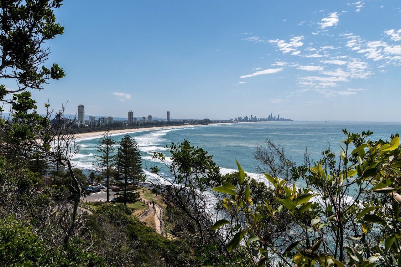 Patrolled golden sand and the headland at Burleigh Heads on the Gold Coast in Queensland Australia