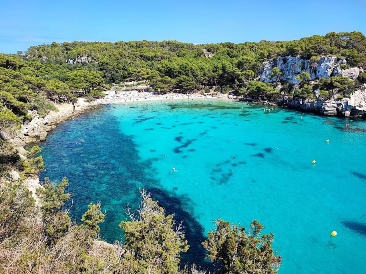 A small, fine sand cove of impossibly clear water reached on foot through pine woods on Menorca's south coast.
