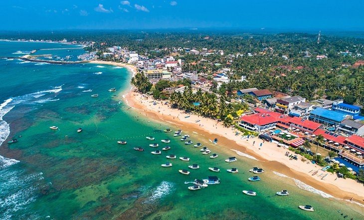 Hikkaduwa Beach long resort strip with reef snorkeling on the Sri Lanka south coast