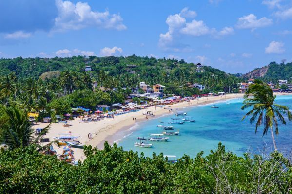 The curved reef sheltered swimming bay of Unawatuna near Galle in Sri Lanka
