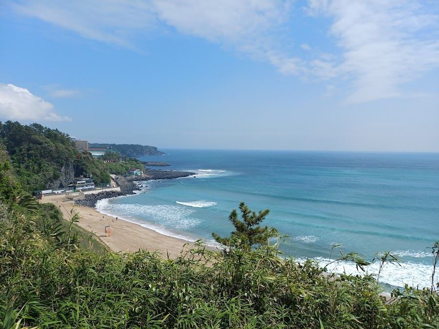 Surf and golden sand at Jungmun Saekdal Beach on the south coast of Jeju