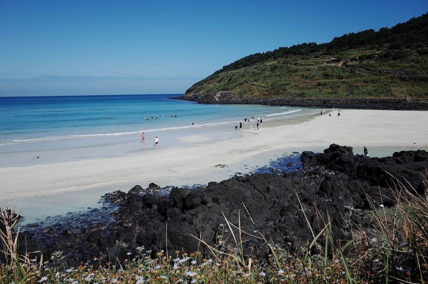 A bright summer day over a turquoise bay and white sand on Jeju Island in South Korea