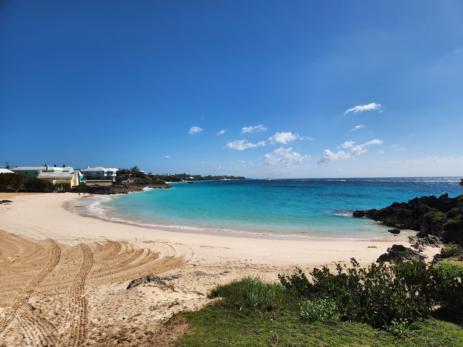 The pink tinted sand and calm turquoise water of John Smiths Bay on the south shore of Bermuda