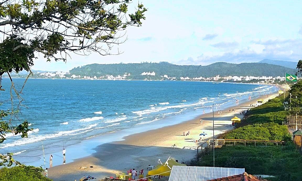 Calm clear water and soft sand along the upscale beach at Jurere Internacional in Florianopolis Brazil