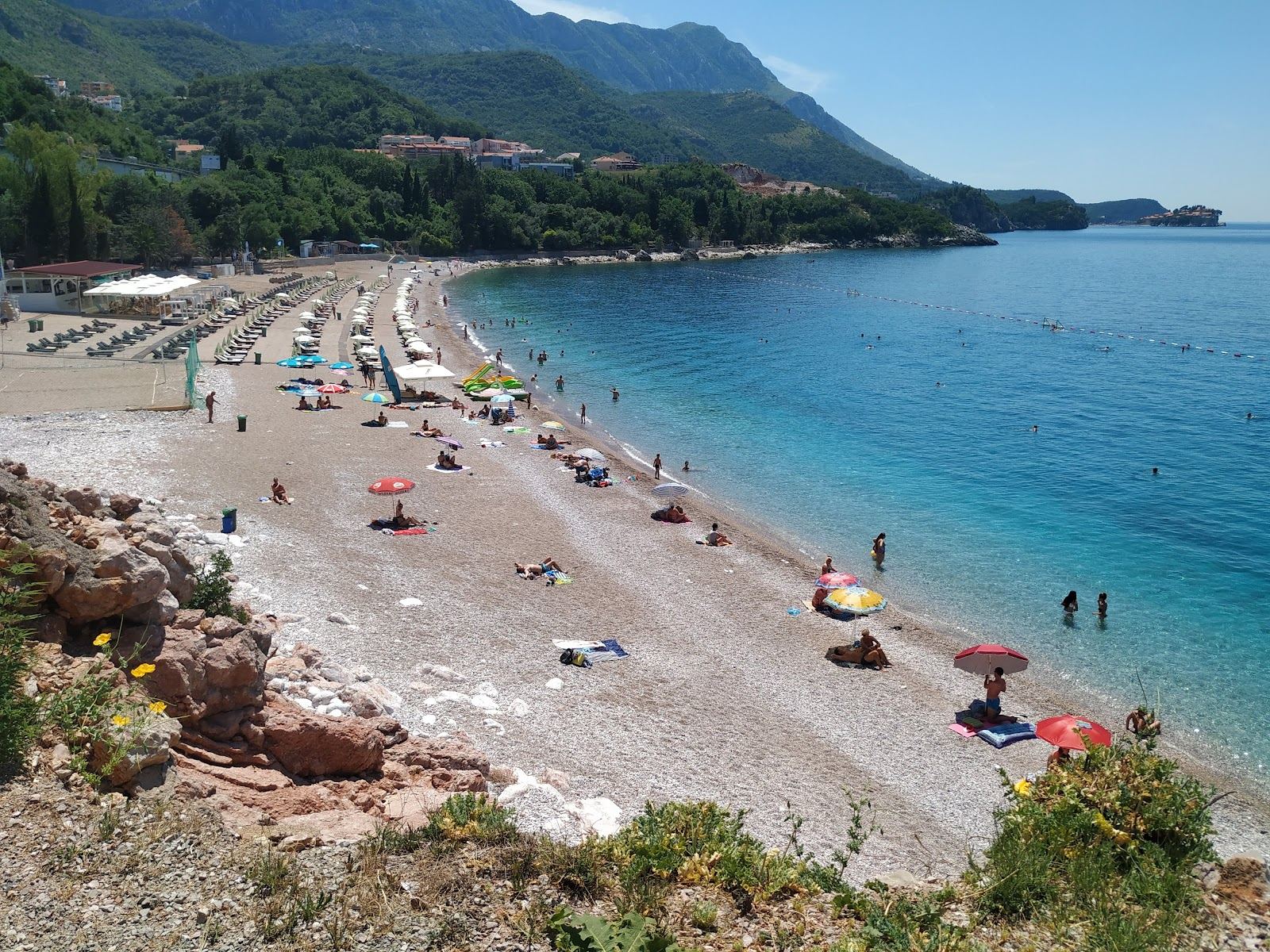 Kamenovo white pebble bay with clear turquoise water east of Becici in Montenegro