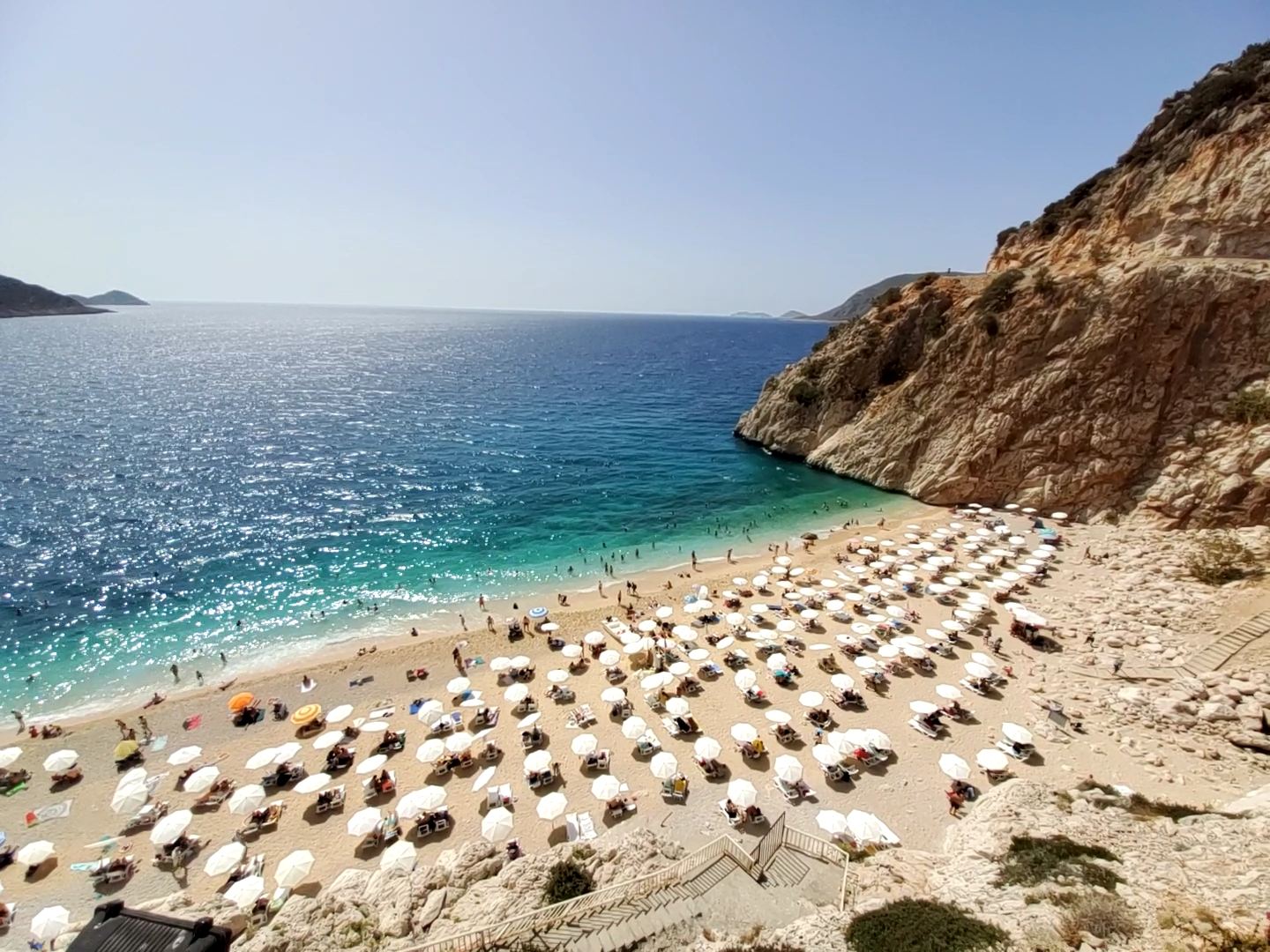 The turquoise water and golden sand of Kaputas beach set in a steep canyon near Kas in Antalya