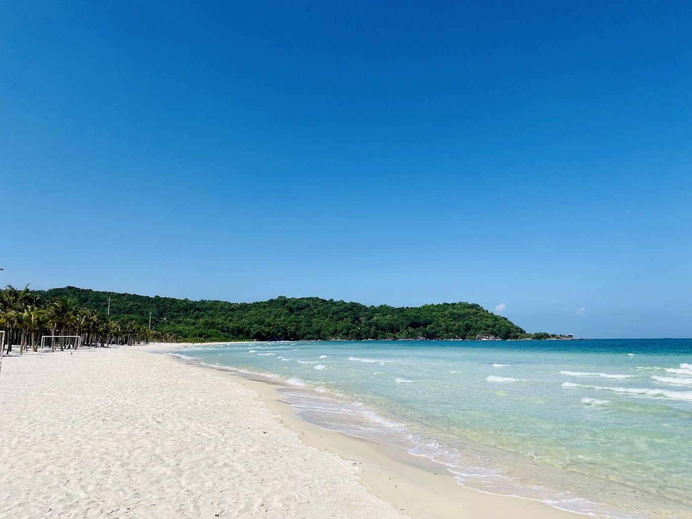 Calm white sand and clear water in the sheltered curve of Bai Khem beach near An Thoi in southern Phu Quoc