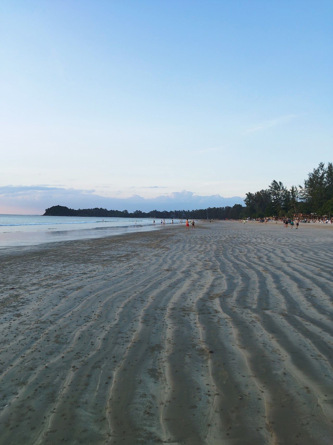 Long soft sand strip and calm shallow water at Klong Dao Beach on Koh Lanta