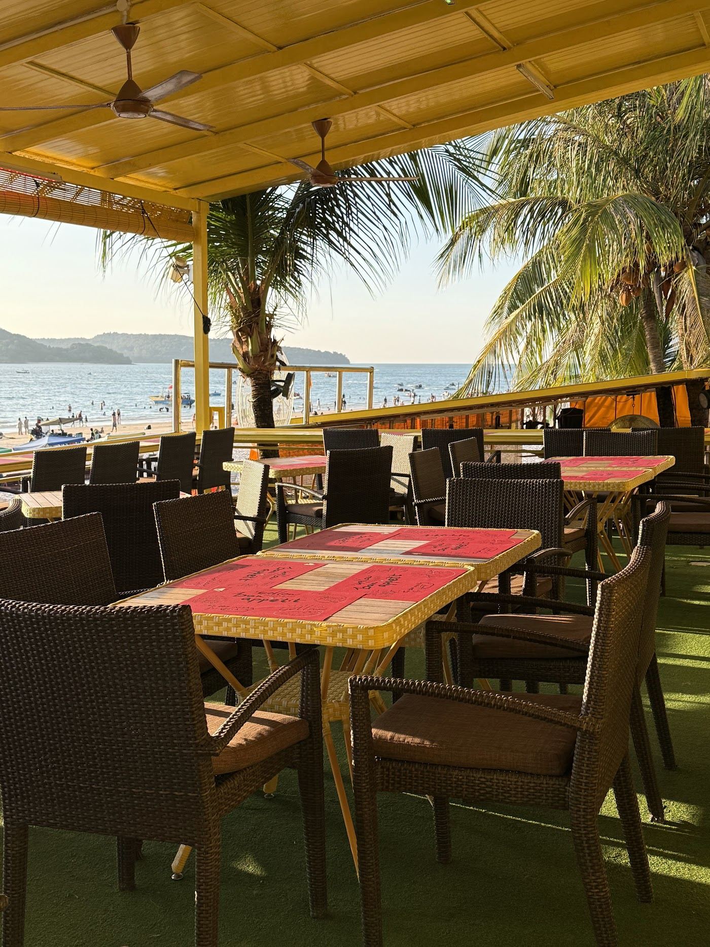 Sunbeds on the sand at a beach club on Pantai Cenang in Langkawi