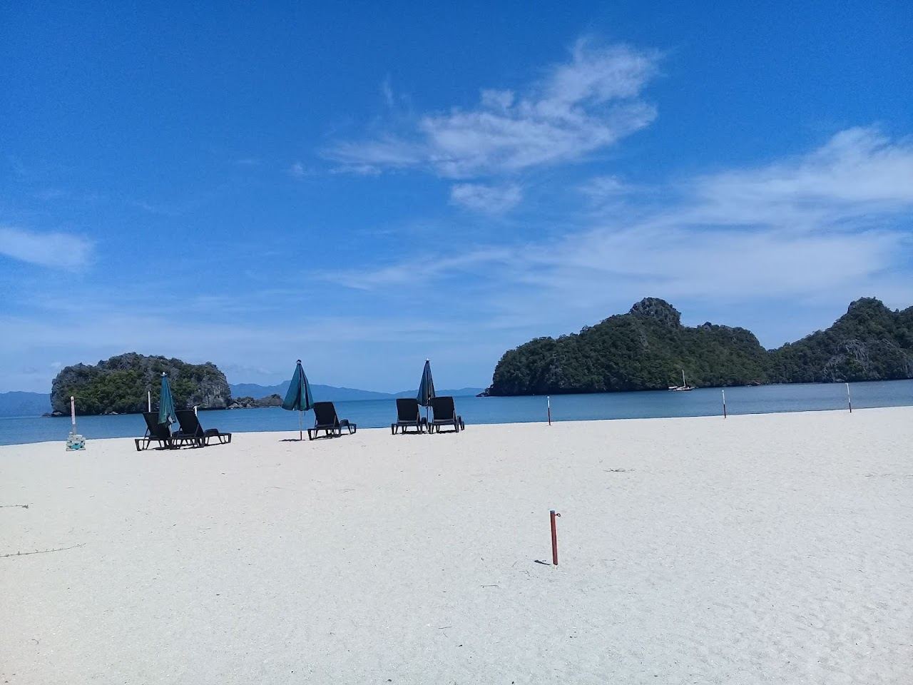 Pale sand, limestone cliffs and calm clear water at Tanjung Rhu in northern Langkawi