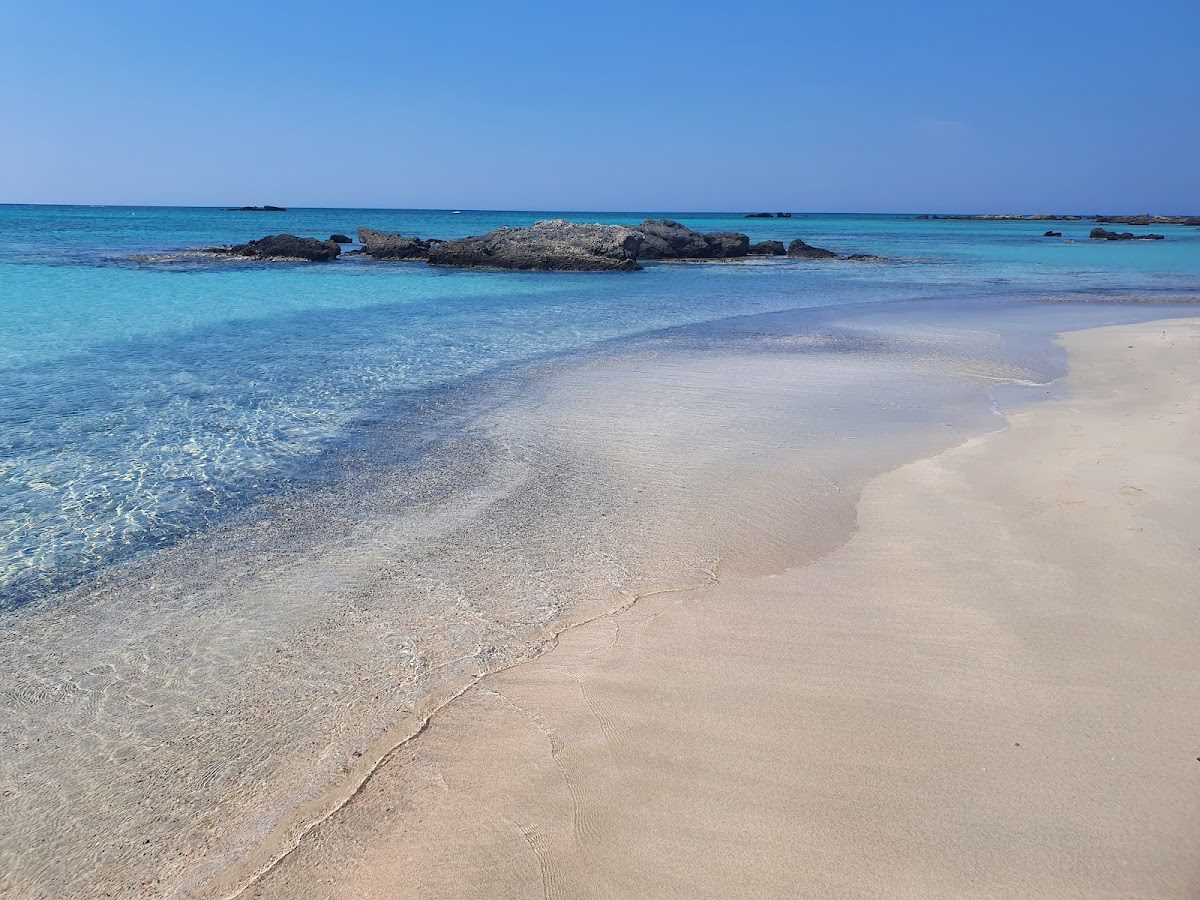 Shallow turquoise lagoon and pale pink sand at Elafonisi on the island of Crete in Greece