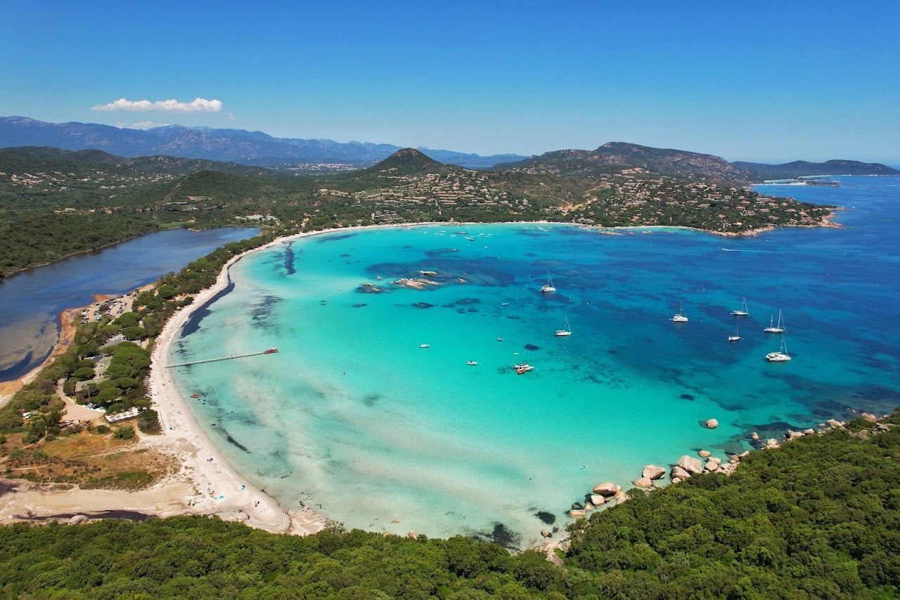 The pale sand and shallow turquoise water of the sheltered Santa Giulia bay near Porto Vecchio, Corsica