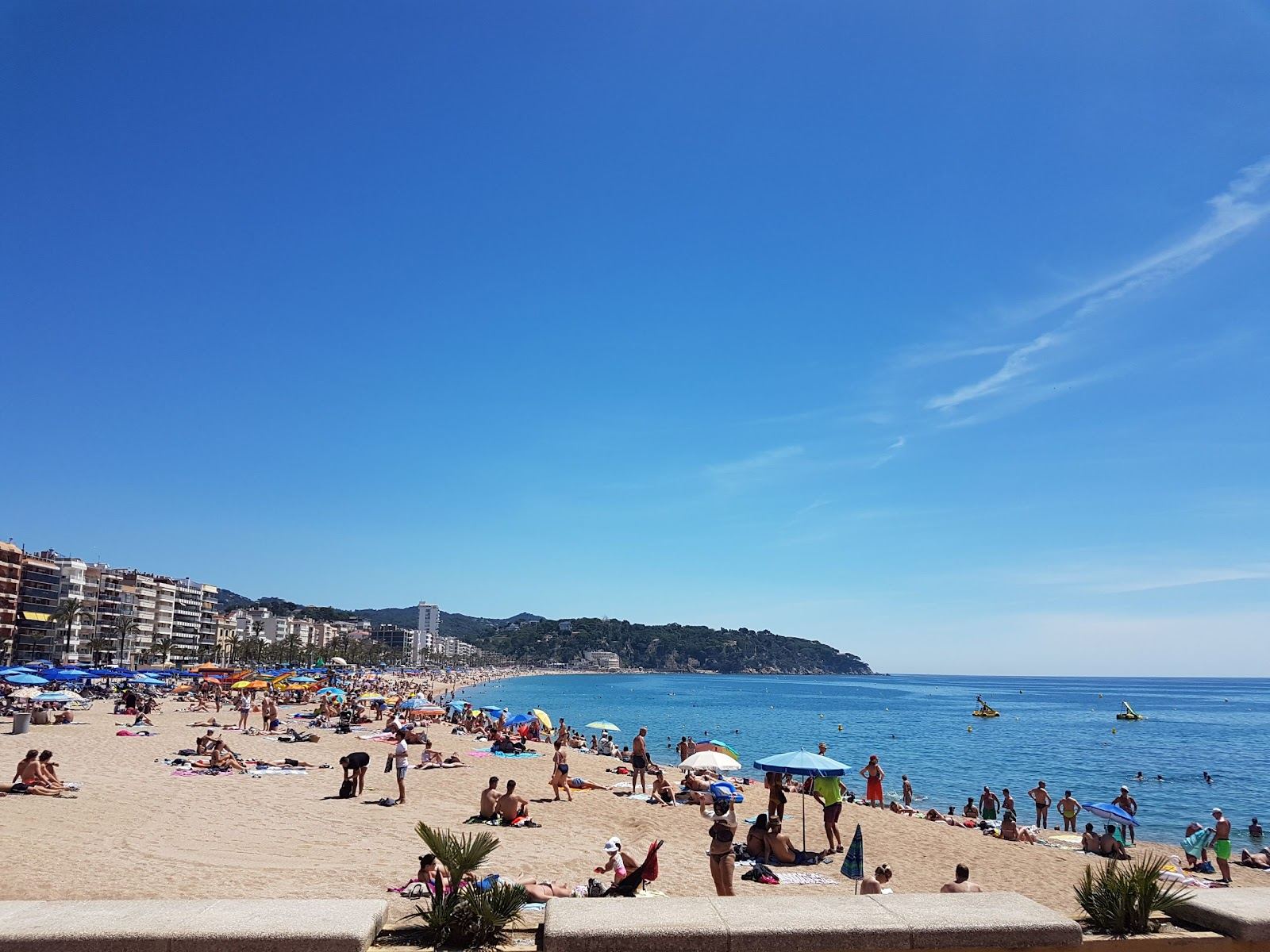 Long sandy main beach backed by a busy promenade at Lloret de Mar on the Costa Brava